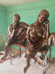 A sculpture of a boy and girl deep in thought